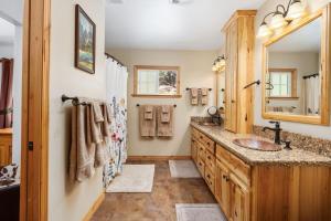 a bathroom with a sink and a mirror at Manzanita Hill-35 miles to Yosemite, 10 miles to Mariposa with 8 person spa in Mariposa +35 photos