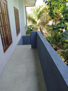 a walkway leading to a door of a house at Ocean whisper residence in Ahangama