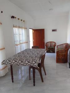 a table and chairs in a room at Ocean whisper residence in Ahangama +7 photos