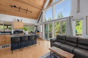 a kitchen and living room with a couch and a table at Raven Haven Lodge by NW Comfy Cabins in Leavenworth