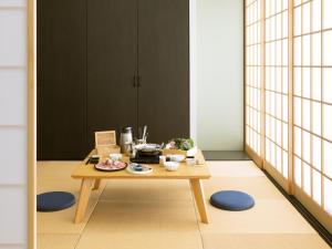 a table with food on it in a room at Homm Stay Yumiha Okinawa By Banyan Group in Onna