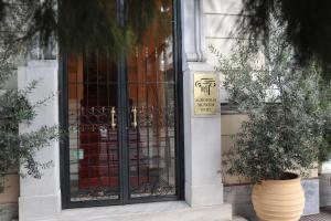 a door to a building with a sign on it at Acropolis Museum Boutique Hotel in Athens