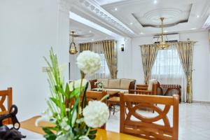 a living room with a table and chairs at MH - Upper Floor Apart in Douala