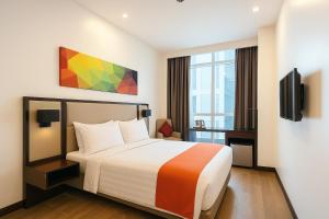 a hotel room with a bed and a tv at Hotel Lucky Chinatown Binondo Manila in Manila +57 photos