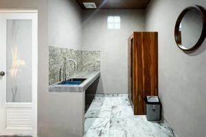 a bathroom with a sink and a mirror at Pondok Sagara Mitra RedDoorz in Kapal
