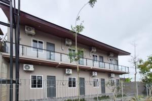 a building with balconies on the side of it at Pondok Sagara Mitra RedDoorz in Kapal +19 photos