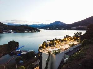 a view of a large body of water at night at Camp Gate Pension Riverview Spa in Gapyeong