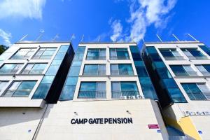 a building with a sign on the front of it at Camp Gate Pension Riverview Spa in Gapyeong