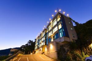 a building with lights on the side of it at Camp Gate Pension Riverview Spa in Gapyeong +8 photos