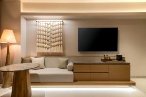 a living room with a couch and a flat screen tv at Grand Hyatt Cancun Beach Resort in Cancún +92 photos