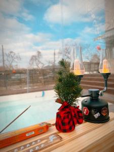 a table with two lamps and a christmas tree next to a window at Dohwa Pension Cheongju in Cheongju