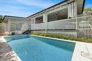 a swimming pool in front of a house at Paddy's Place in Bangalow