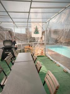 a tent with a table and chairs and a swimming pool at Dohwa Pension Cheongju in Cheongju +7 photos