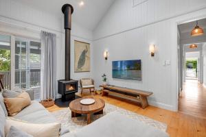 a living room with a couch and a wood stove at Paddy's Place in Bangalow