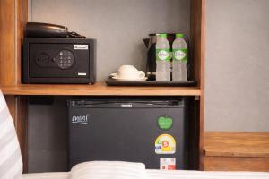 a microwave and a radio sitting on a shelf at The Homey Boutique Rawai in Rawai Beach +17 photos