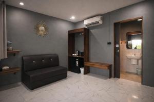 a waiting room with a chair and a sink at The Homey Boutique Rawai in Rawai Beach