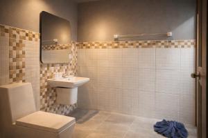 a bathroom with a sink and a toilet at The Homey Boutique Rawai in Rawai Beach