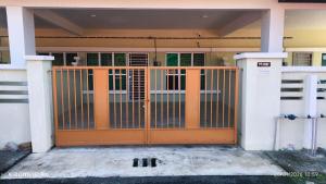 an orange gate in the front of a house at k homestay in Jeli