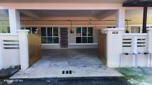 an empty entry to a house with a garage at k homestay in Jeli +2 photos