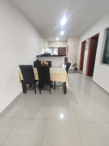 a dining room and kitchen with a table and chairs at k homestay in Jeli