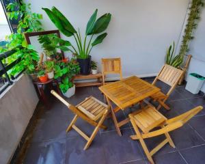 a patio with a table and chairs and plants at Khách sạn Giao Thông in Hanoi +18 photos
