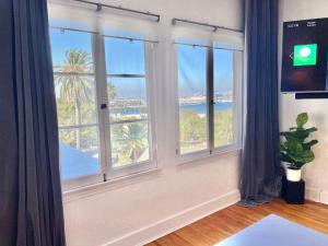 a room with windows with a view of the ocean at The Riviera in San Pedro