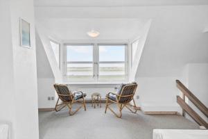 two chairs and a table in a room with a window at 369-Lemvig-Klostervej-39 in Lemvig