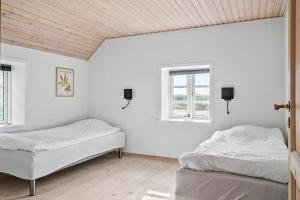 two beds in a white room with two windows at 369-Lemvig-Klostervej-39 in Lemvig