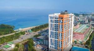 an orange and white building next to the ocean at Donghae Eoul Stay in Donghae