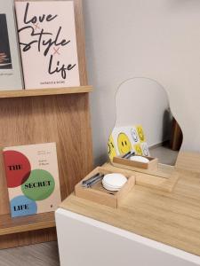 a desk with a light up lamp and a mirror at Donghae Eoul Stay in Donghae +10 photos