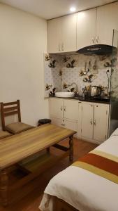 a kitchen with white cabinets and a wooden table at Kathmandu Peace Guesthouse in Kathmandu