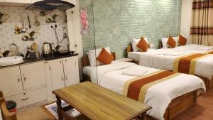 a hotel room with two beds and a sink at Kathmandu Peace Guesthouse in Kathmandu +25 photos