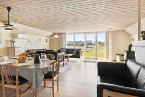 a living room with a table and some chairs at 377-Harboore-Fourmivej-56 in Harboør