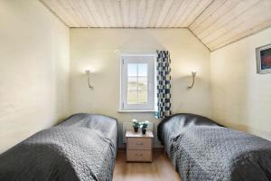 a bedroom with two beds and a window at 377-Harboore-Fourmivej-56 in Harboør