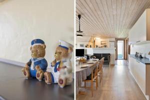 two teddy bears sitting on a table in a kitchen at 377-Harboore-Fourmivej-56 in Harboør