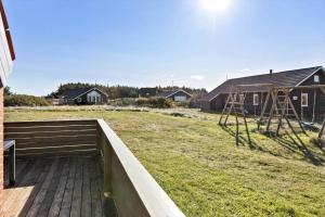 a view of a backyard with a bench and a playground at 377-Harboore-Fourmivej-56 in Harboør