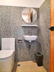 a bathroom with a sink and a mirror at Alzurich Private Resort in Dauin +10 photos