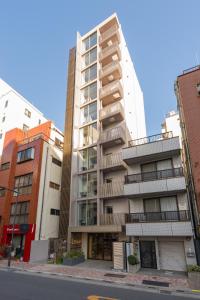 a tall building on a city street with buildings at Sumu Ueno East in Tokyo