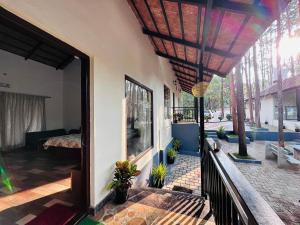 a porch of a house with a patio at janani ecostay in Chikmagalūr