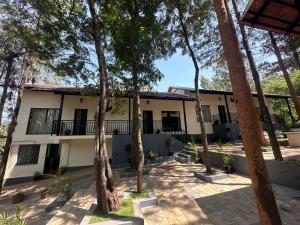 a building with trees in front of it at janani ecostay in Chikmagalūr