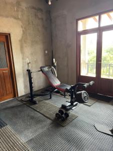a room with a exercise bike and a window at River Breeze Villa in Nikawatawana