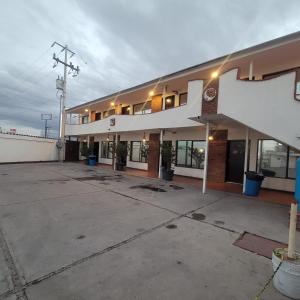an empty parking lot in front of a building at hotel villa del sol chihuahua in Chihuahua