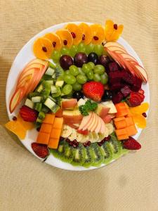 a plate of fruit and vegetables on a table at Hotel Tenki Kathmandu in Kathmandu