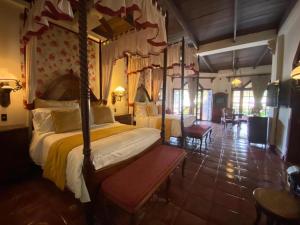 a bedroom with a canopy bed in a room at Hotel Tropicana Castle Sabang Mindoro in Sabang +51 photos