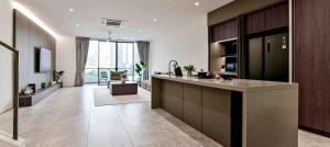 a large kitchen with a counter and a living room at Modern Luxury Villa Hinai by Simple Sanctuary in George Town