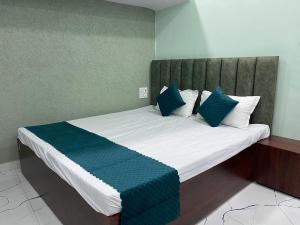 a large bed with blue and white pillows on it at Hotel S S A in Orchha +9 photos