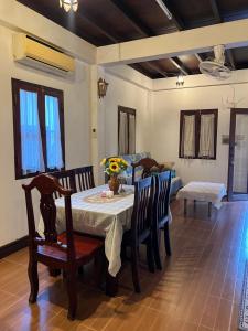 a dining room with a table and chairs at Mary's House Xiengthong in Luang Prabang