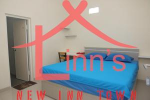 a room with a bed with a x marks on the wall at linns house borobudur syariah malang in Blimbing