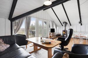 a living room with a table and leather chairs at 2555-Romo-A-M-Listsvej-6 in Høm