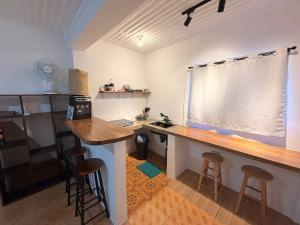 a kitchen with a desk and stools in a room at New studio General Luna in General Luna